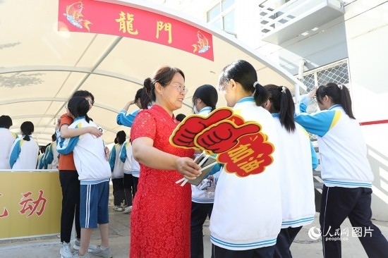 6月7日一早，雄安新區(qū)安新中學(xué)老師在給同學(xué)們加油鼓勁兒。人民網(wǎng) 李兆民攝
