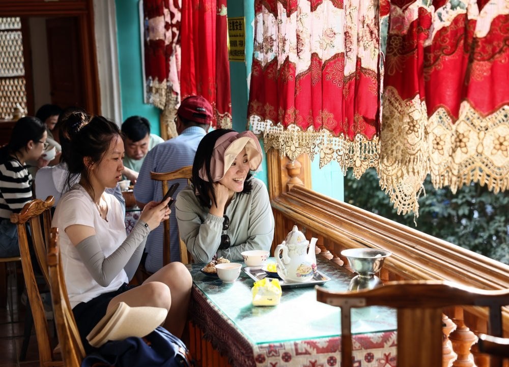 游客在新疆喀什古城景區(qū)百年老茶館內(nèi)品茶小憩（2023年9月7日攝）。新華社記者 蘭紅光 攝