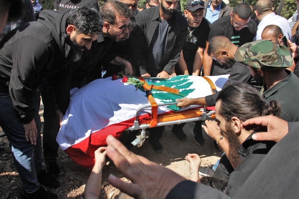 10月14日，黎巴嫩南部希亞姆鎮(zhèn)，黎巴嫩記者和民眾為在以色列轟炸中死亡的攝影記者伊薩姆·阿卜杜拉送葬。新華社發(fā)（塔希爾·阿布·哈姆丹攝）