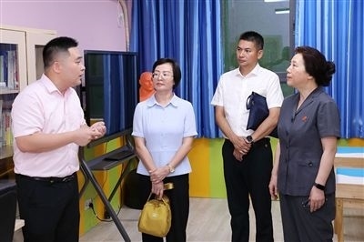 圖③：“小公民法律課堂”開(kāi)講前，全國(guó)人大代表殷其龍（右二）、重慶市人大代表李自玲（左二）聽(tīng)取楊家坪中學(xué)負(fù)責(zé)人關(guān)于未成年人思想教育工作情況的介紹。