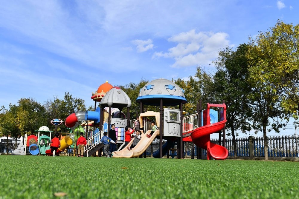 在山東省東營市墾利區(qū)楊廟社區(qū)幼兒園，孩子們在老師的帶領(lǐng)下進(jìn)行戶外活動（2021年10月19日攝）。新華社記者 郭緒雷 攝