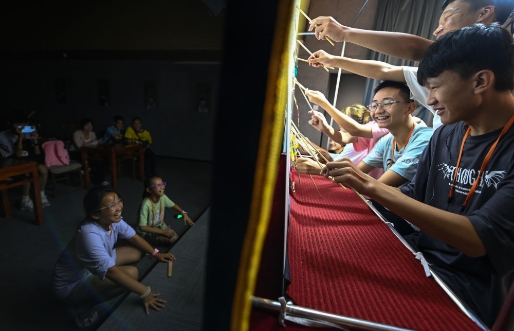 2023年8月8日，進(jìn)行暑期研學(xué)的學(xué)生在位于陜西省西安市的中國(guó)秦腔藝術(shù)博物館體驗(yàn)皮影戲演出。新華社記者 鄒競(jìng)一 攝