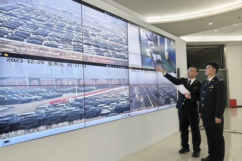海關(guān)關(guān)員視頻巡查出口汽車場地。李進(jìn)攝