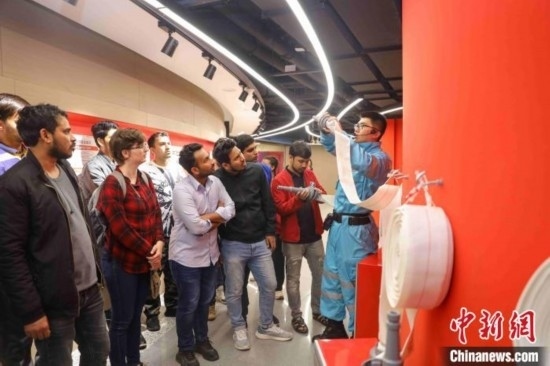 5月9日，工作人員指導留學生正確使用消防水帶。張鷹 攝