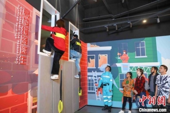 5月9日，留學生體驗模擬高樓緩降逃生。張鷹 攝