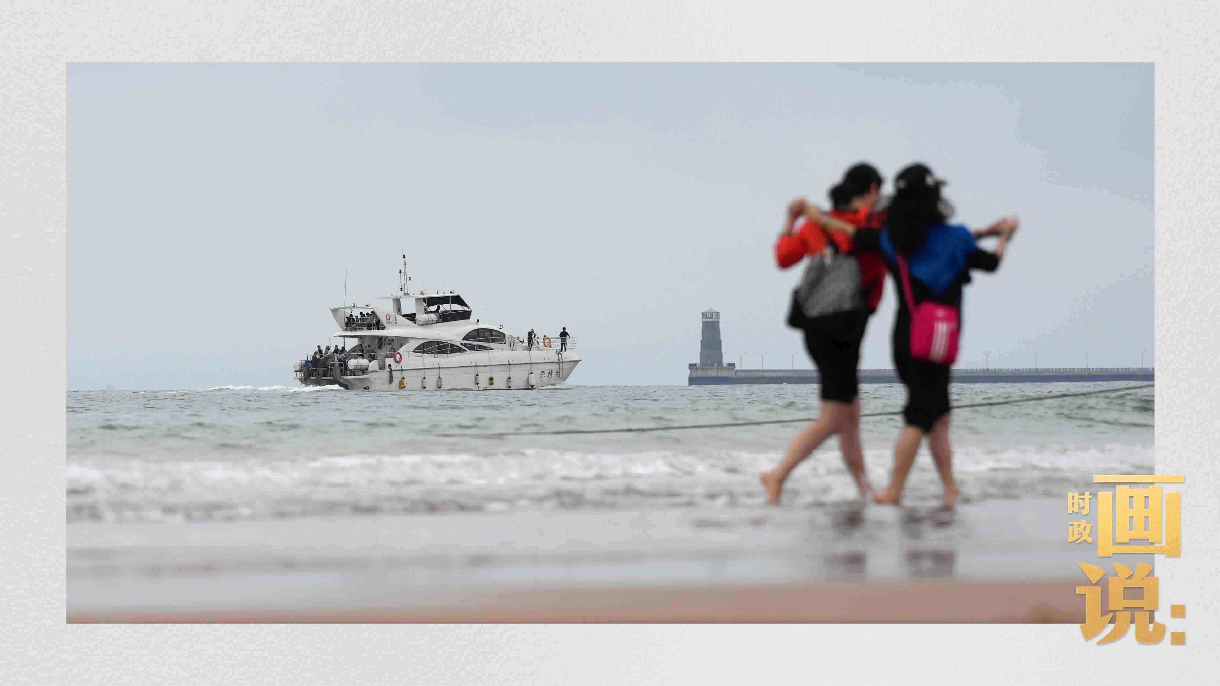 △日照陽光海岸綠道上的萬平口景區(qū)，一對游客在海浪中翩然起舞。