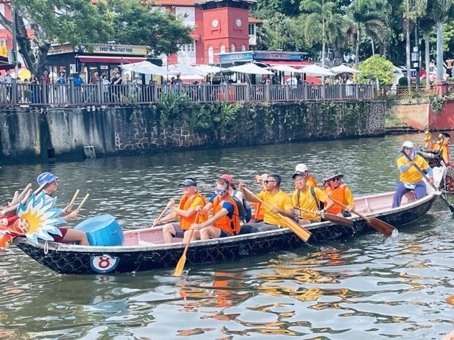 多元種族共同奮輯前進(jìn)，體驗(yàn)在馬六甲河劃龍舟，引來大批游客駐足圍觀。組委會(huì)供圖