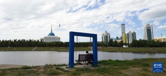 6月30日，一名女子在哈薩克斯坦首都阿斯塔納伊希姆河畔休息。新華社記者 王建華 攝