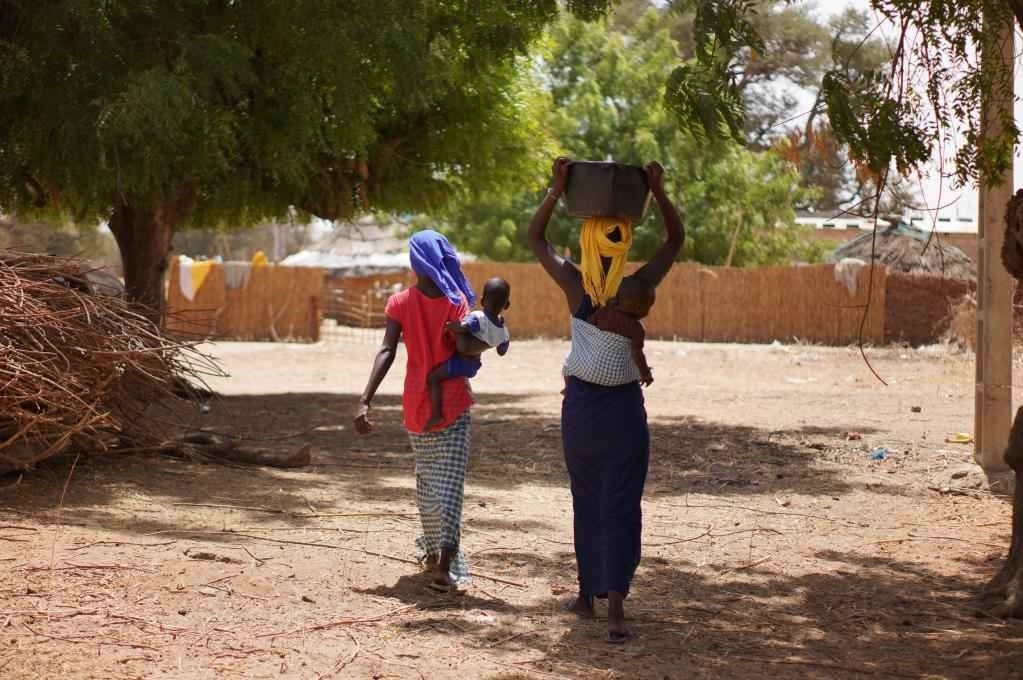 2023年3月20日，在塞內(nèi)加爾久爾貝勒區(qū)的泰內(nèi)富勒村，村民將取到的水運(yùn)回家。新華社記者 王子正 攝