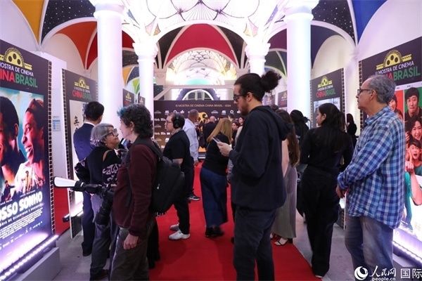 為期4天的第三屆中國－巴西電影展期間，來自中巴兩國的14部參展影片受到巴西電影愛好者和社會各界人士好評，圖為當(dāng)?shù)赜^眾在影展舉辦地巴西里約熱內(nèi)盧勞拉—阿爾維姆文化之家的迎賓廳欣賞參展電影海報(bào)。 人民網(wǎng)記者 陳一鳴攝