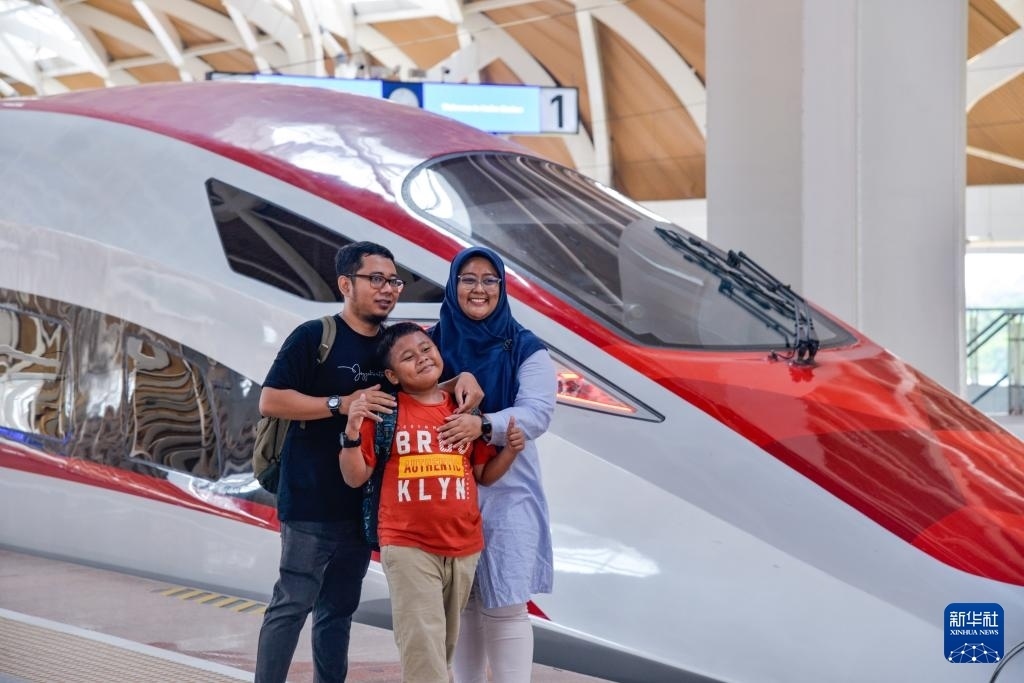 4月17日，在印度尼西亞雅加達(dá)哈利姆站站臺(tái)，乘客和雅萬高鐵高速動(dòng)車組列車合影。新華社記者 徐欽 攝