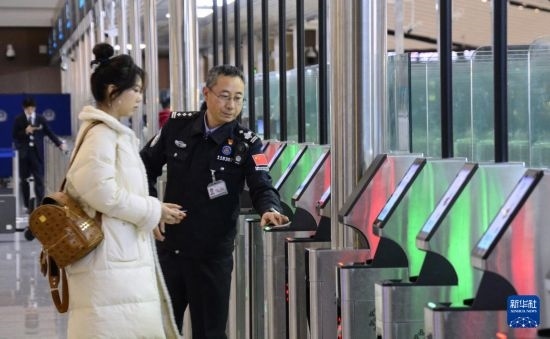 1月2日，大興機(jī)場(chǎng)邊檢站警察指導(dǎo)旅客使用自助出境設(shè)備。新華社記者 李欣 攝