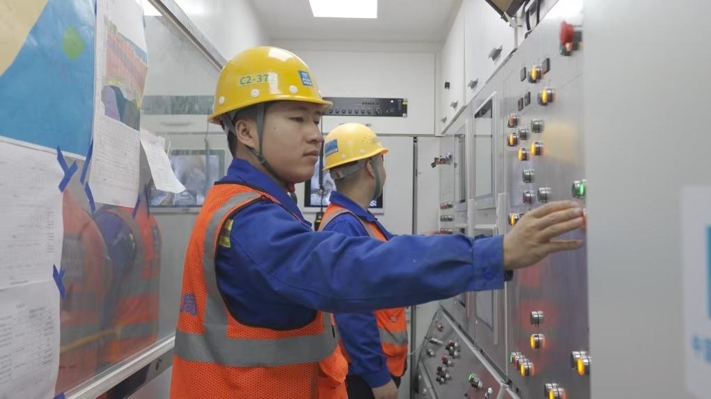 盾構(gòu)司機何曉波在駕駛室內(nèi)調(diào)試盾構(gòu)機參數(shù)。（劉芬攝）