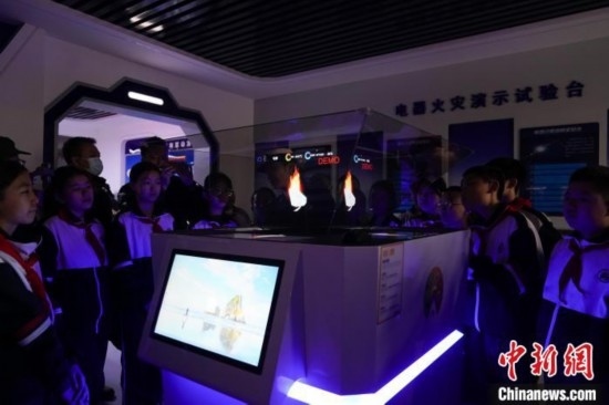 圖為學(xué)生們參觀道里區(qū)消防救援大隊(duì)消防科普體驗(yàn)館內(nèi)幻影成像燃燒三要素實(shí)驗(yàn)臺(tái)。中新社記者 趙宇航 攝