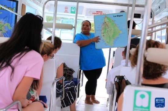 3月15日，一名導游在游艇上為游客介紹塞舌爾拉迪格島。新華社記者 董江輝 攝