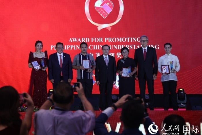 黃溪連大使和菲中了解協(xié)會主席與榮獲“友誼獎”的獲獎者合影留念。人民網(wǎng)記者 樊帆攝